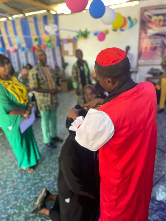 The Bishop vesting a newly ordained minister