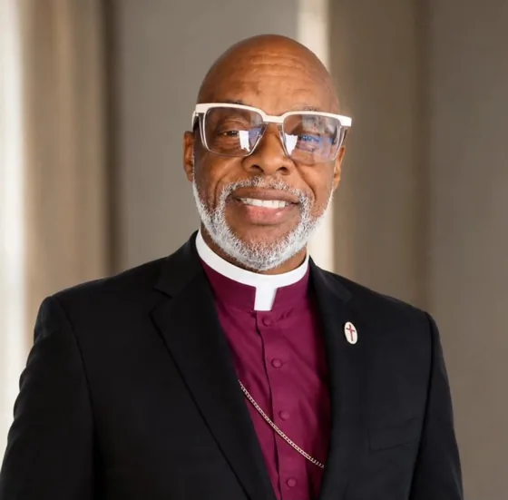 Bishop David J. Davis in a purple clerical shirt and black suit
