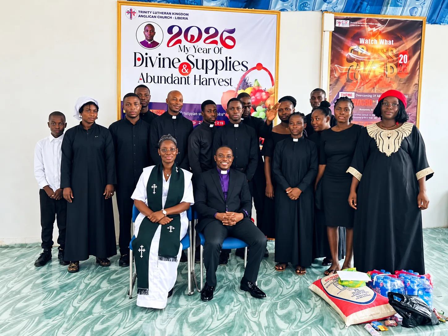 The pastors and ministers of Christ Laborers Church, in black clerical dress, with two leaders seated in front