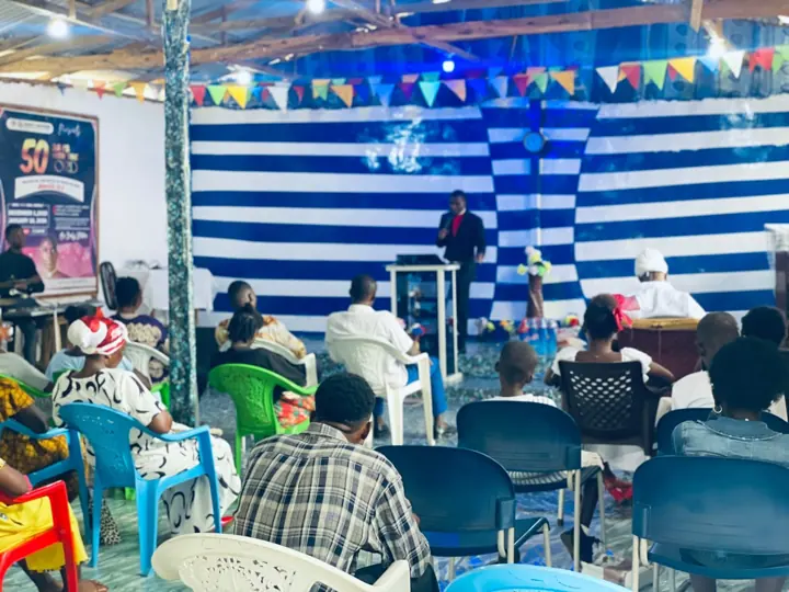 The congregation listening to a sermon in the blue-and-white sanctuary
